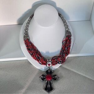 Multi-strand coral and turquoise necklace with a silver-toned cross pendant.